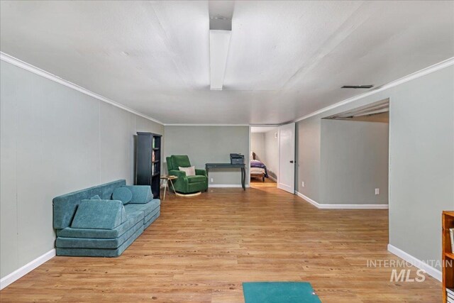 1984 11th Ave E, Twin Falls, ID 83301 - living area featuring light wood-style flooring, ornamental molding, and baseboards