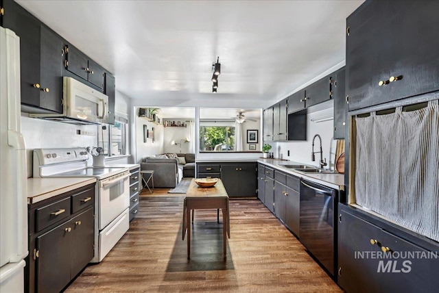 1984 11th Ave E, Twin Falls, ID 83301 - kitchen featuring white appliances, a sink, wood finished floors, light countertops, and ceiling fan
