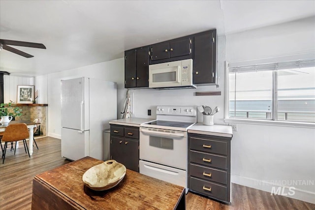 1984 11th Ave E, Twin Falls, ID 83301 - kitchen with white appliances, ceiling fan, wood finished floors, tasteful backsplash, and light countertops