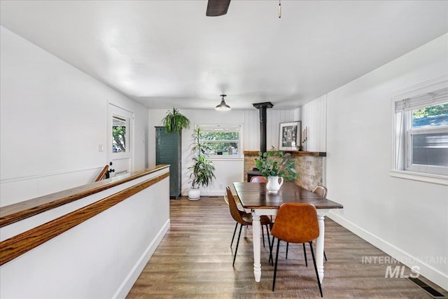 1984 11th Ave E, Twin Falls, ID 83301 - dining area with healthy amount of natural light, a wood stove, and wood finished floors