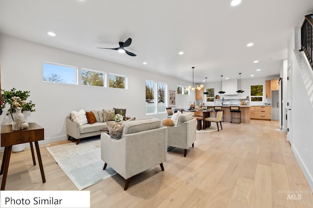 living area featuring recessed lighting, light wood-type flooring, baseboards, and a ceiling fan