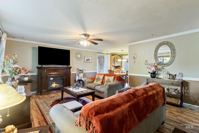 2819 Gemini, Caldwell, ID 83605 - living area with a ceiling fan, a glass covered fireplace, crown molding, baseboards, and a chandelier