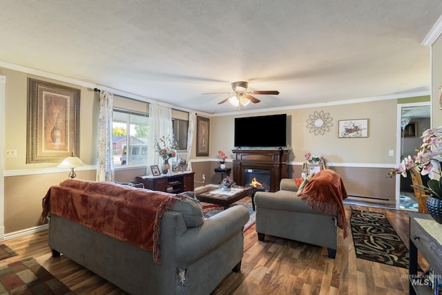 2819 Gemini, Caldwell, ID 83605 - living area with a ceiling fan, ornamental molding, a glass covered fireplace, wood finished floors, and baseboards