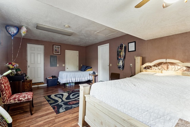 2819 Gemini, Caldwell, ID 83605 - bedroom featuring attic access, wood finished floors, electric panel, a ceiling fan, and a textured ceiling