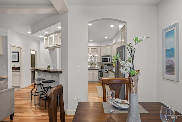 dining space with light hardwood / wood-style flooring