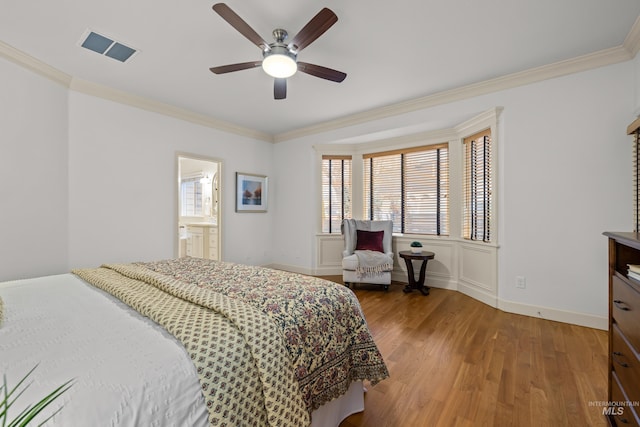 bedroom featuring wood-type flooring, ceiling fan, and crown molding