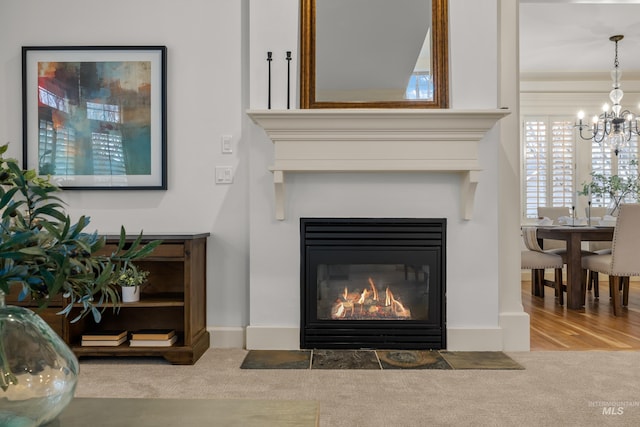 room details featuring a chandelier and carpet flooring