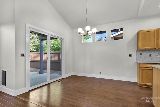3742 N Heritage View Ave, Meridian, ID 83646 - unfurnished dining area with dark wood-style floors, a chandelier, vaulted ceiling, and baseboards