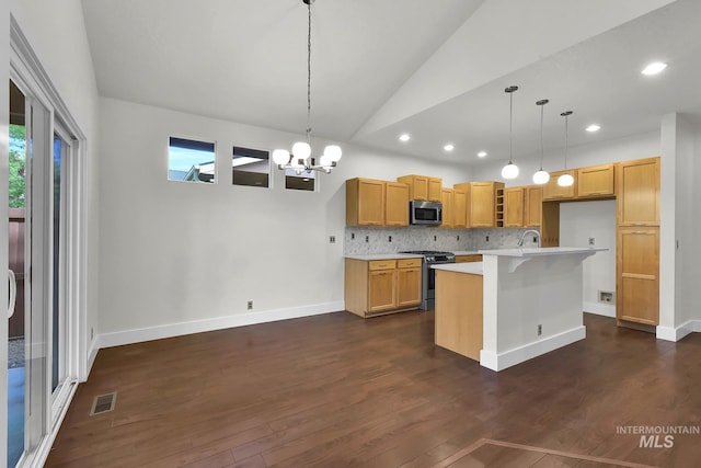 3742 N Heritage View Ave, Meridian, ID 83646 - kitchen featuring stainless steel appliances, vaulted ceiling, light countertops, decorative backsplash, and a chandelier