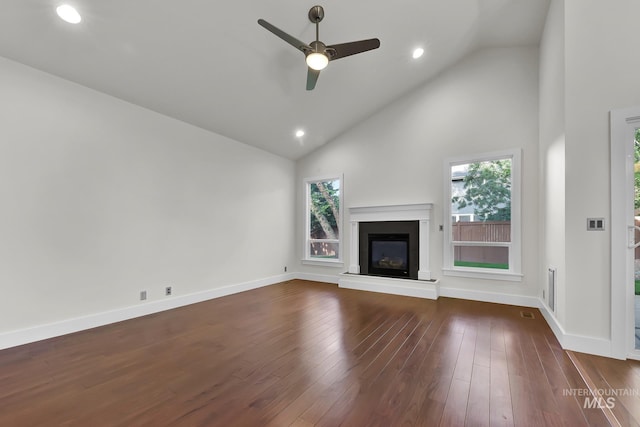 3742 N Heritage View Ave, Meridian, ID 83646 - unfurnished living room with plenty of natural light, ceiling fan, high vaulted ceiling, a glass covered fireplace, and dark wood-style flooring