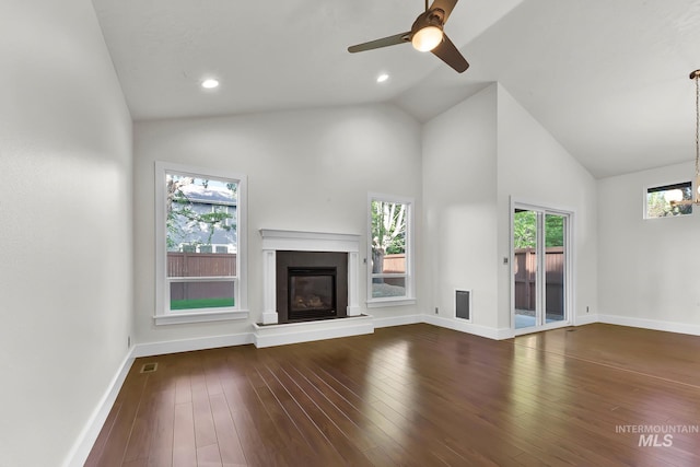 3742 N Heritage View Ave, Meridian, ID 83646 - unfurnished living room featuring a glass covered fireplace, baseboards, ceiling fan, high vaulted ceiling, and dark wood-style flooring