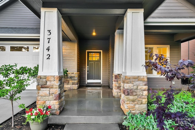 3742 N Heritage View Ave, Meridian, ID 83646 - view of exterior entry with stone siding, covered porch, and a garage