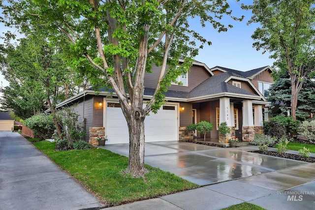 3742 N Heritage View Ave, Meridian, ID 83646 - craftsman-style house with stone siding, concrete driveway, an attached garage, and a porch