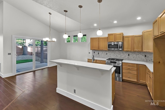 3742 N Heritage View Ave, Meridian, ID 83646 - kitchen with appliances with stainless steel finishes, light countertops, decorative backsplash, dark wood finished floors, and decorative light fixtures