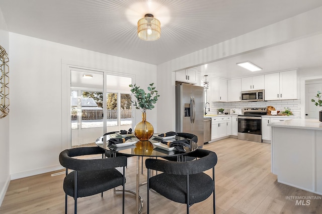 dining space featuring light hardwood / wood-style flooring