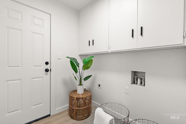 laundry room with cabinets, washer hookup, hookup for an electric dryer, and light hardwood / wood-style flooring