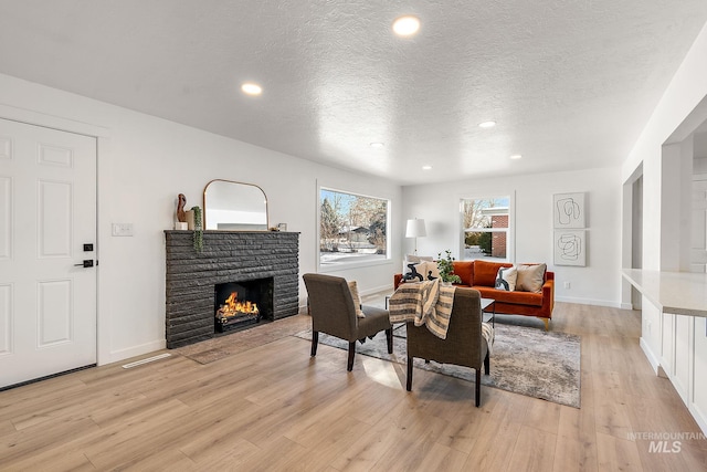 living room featuring a textured ceiling and light hardwood / wood-style flooring