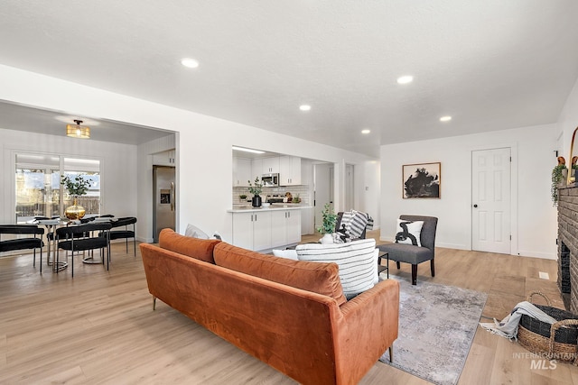 living room with light hardwood / wood-style flooring and a fireplace