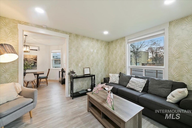 living room featuring a chandelier and light hardwood / wood-style flooring