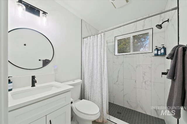 bathroom featuring curtained shower, vanity, and toilet