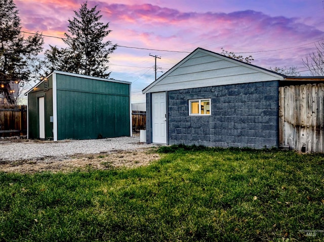 outdoor structure at dusk with a yard