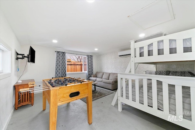 bedroom featuring concrete flooring and a wall mounted AC