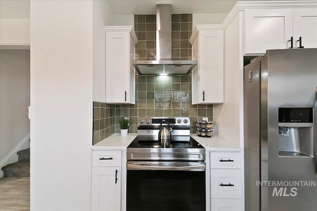 kitchen with white cabinets, wall chimney exhaust hood, backsplash, and stainless steel appliances