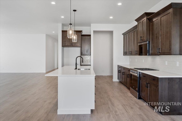 5278 W Mcnair St, Meridian, ID 83646 - kitchen with a sink, gas range, backsplash, dark brown cabinets, and recessed lighting