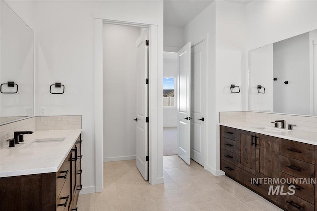 5278 W Mcnair St, Meridian, ID 83646 - bathroom with decorative backsplash, two vanities, and baseboards