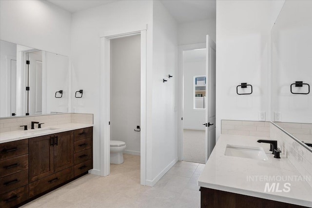 5278 W Mcnair St, Meridian, ID 83646 - full bathroom with vanity, toilet, decorative backsplash, and tile patterned floors