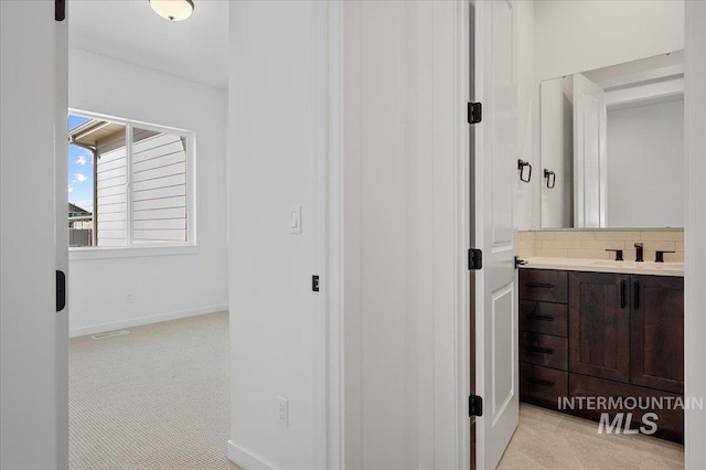 5278 W Mcnair St, Meridian, ID 83646 - bathroom featuring vanity, backsplash, and baseboards