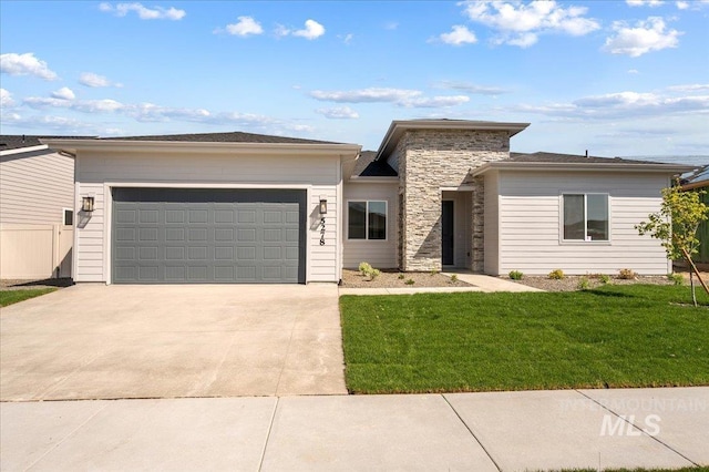 5278 W Mcnair St, Meridian, ID 83646 - prairie-style house featuring an attached garage, concrete driveway, a front yard, and stone siding