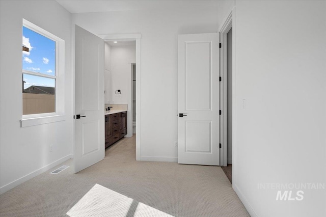 5278 W Mcnair St, Meridian, ID 83646 - unfurnished bedroom featuring baseboards, light colored carpet, and ensuite bathroom