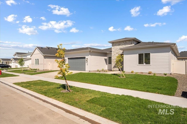 5278 W Mcnair St, Meridian, ID 83646 - view of front facade with concrete driveway, an attached garage, and stone siding