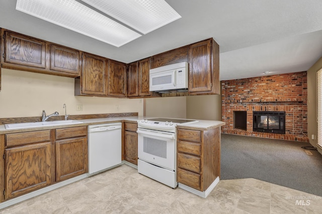 955 Bitterroot Pl, Twin Falls, ID 83301 - kitchen with white appliances, a sink, a brick fireplace, light countertops, and open floor plan