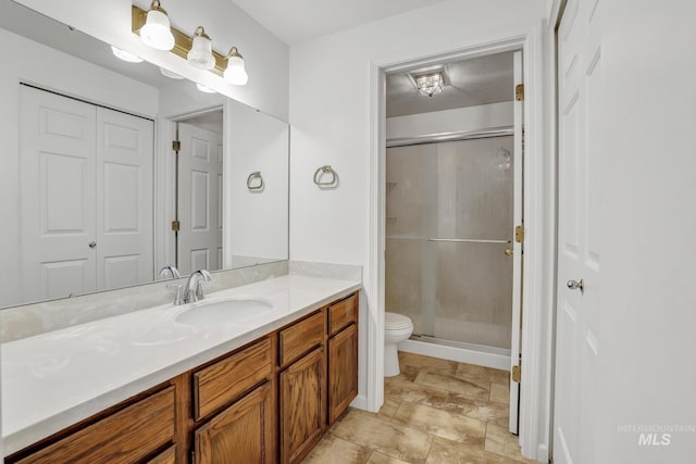 955 Bitterroot Pl, Twin Falls, ID 83301 - bathroom featuring toilet, vanity, and a stall shower