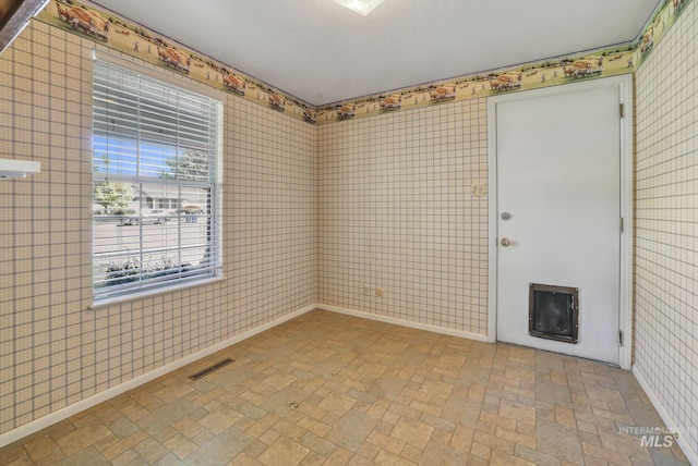 955 Bitterroot Pl, Twin Falls, ID 83301 - unfurnished room with brick patterned floors, wallpapered walls, and baseboards