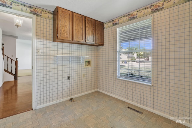 955 Bitterroot Pl, Twin Falls, ID 83301 - laundry area with cabinet space, hookup for an electric dryer, baseboards, wallpapered walls, and washer hookup