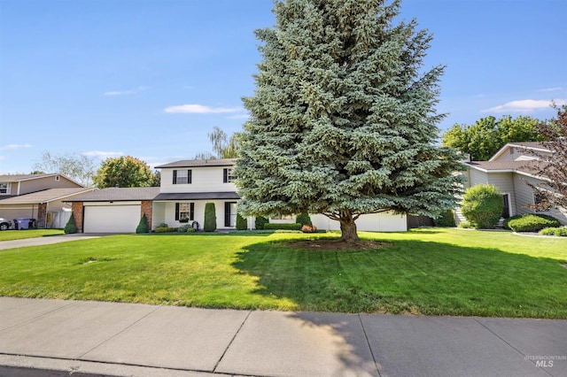 955 Bitterroot Pl, Twin Falls, ID 83301 - traditional-style home featuring driveway, an attached garage, a front lawn, and brick siding
