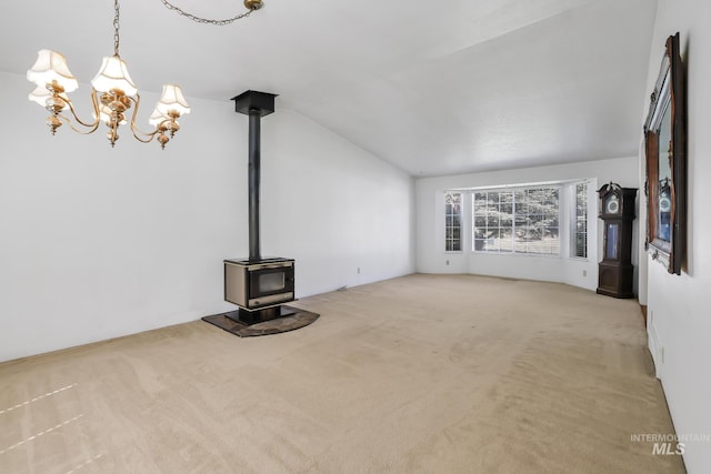 955 Bitterroot Pl, Twin Falls, ID 83301 - unfurnished living room featuring carpet, a wood stove, a chandelier, and vaulted ceiling