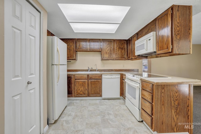 955 Bitterroot Pl, Twin Falls, ID 83301 - kitchen with white appliances, a sink, light countertops, and brown cabinetry