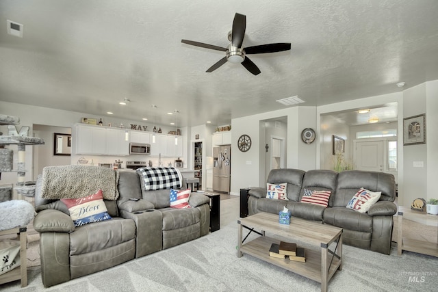 2982 W Mcintosh, Kuna, ID 83634 - living room with ceiling fan, light carpet, recessed lighting, and a textured ceiling