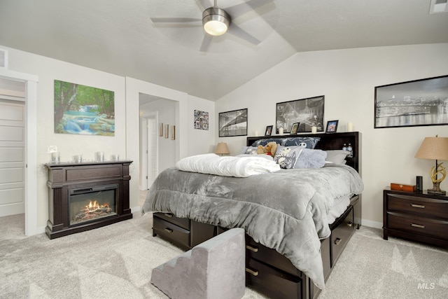 2982 W Mcintosh, Kuna, ID 83634 - bedroom featuring vaulted ceiling, carpet, a glass covered fireplace, ceiling fan, and baseboards