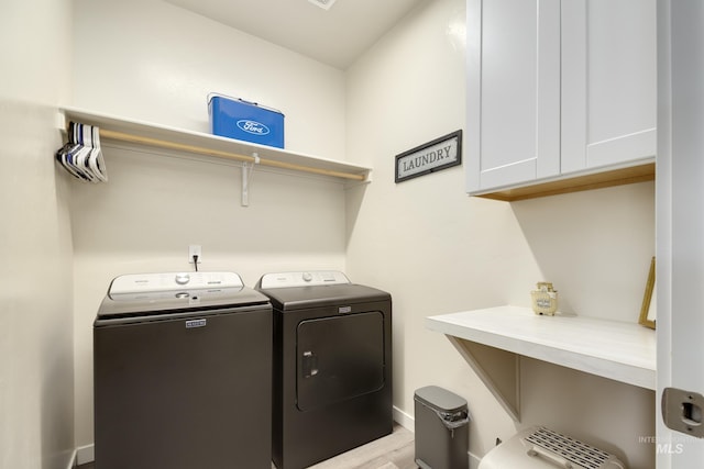 2982 W Mcintosh, Kuna, ID 83634 - laundry area with washing machine and clothes dryer, cabinet space, baseboards, and light wood finished floors