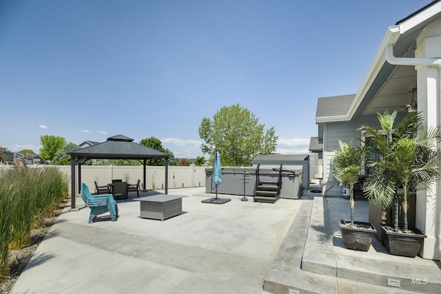 2982 W Mcintosh, Kuna, ID 83634 - fenced backyard with a hot tub, a patio area, a gazebo, and an outdoor hangout area