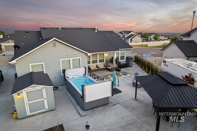 2982 W Mcintosh, Kuna, ID 83634 - rear view of house featuring an outdoor living space, a patio, a fenced backyard, a hot tub, and a residential view