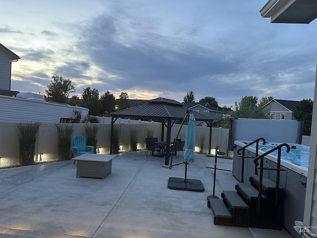 2982 W Mcintosh, Kuna, ID 83634 - fenced backyard featuring a patio area, outdoor dining area, a gazebo, and a hot tub