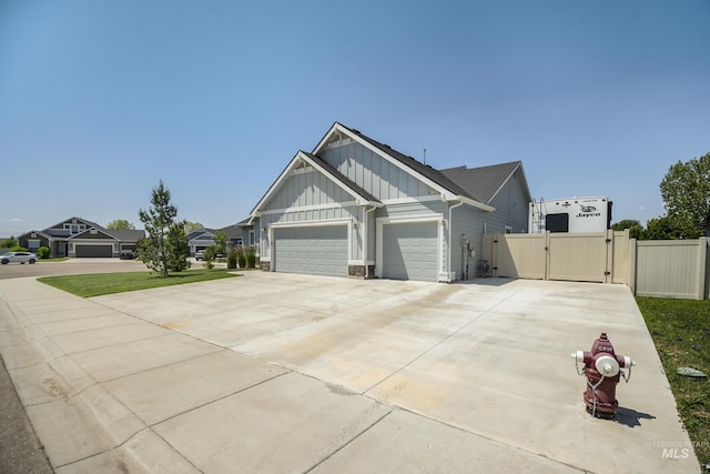 2982 W Mcintosh, Kuna, ID 83634 - craftsman inspired home with board and batten siding, a gate, a garage, and driveway