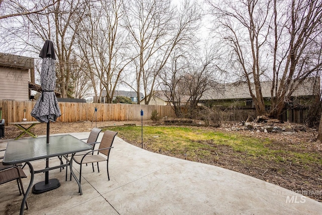 view of patio with a fenced backyard and outdoor dining space