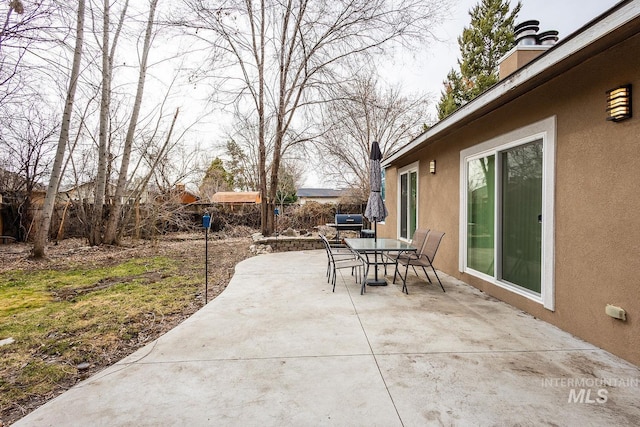 view of patio / terrace featuring outdoor dining area and fence